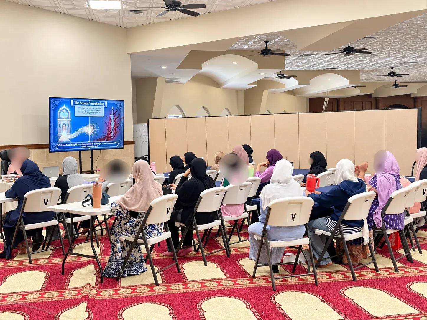 Girls at tables facing a slide titled The Scholar’s Awakening